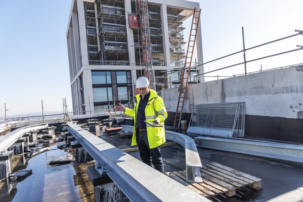 Architect inspects work at building site