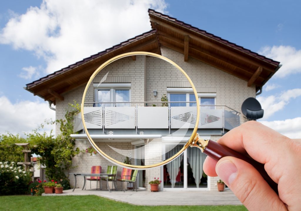 Magnifying Glass Inspecting House